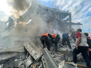 Palestinians inspect the site of an Israeli strike on a house in Rafah