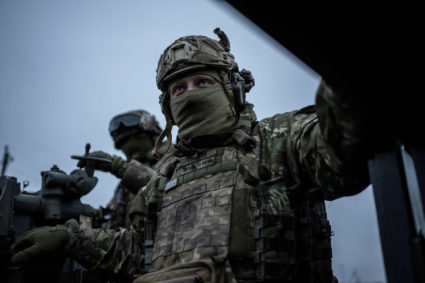 Ukrainian service members are seen atop a S60 cannon near the front-line town of Bakhmut