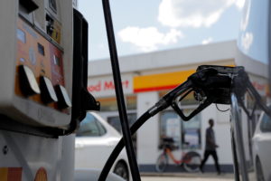A gas pump is seen in a car at a Shell gas station, after a cyberattack crippled the biggest fuel pipeline in the country,...