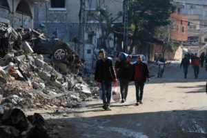 Palestinians flee their houses after they were ordered by the Israeli army to evacuate the area in Bureij