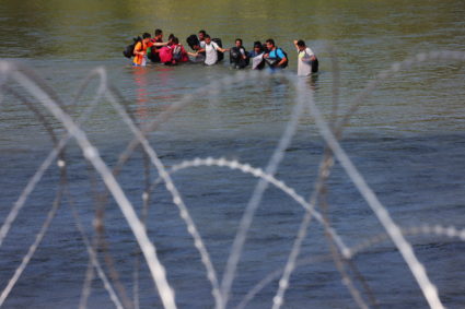 FILE PHOTO: Migrants cross the Rio Grande into the United States in Eagle Pass, Texas, U.S., September 26, 2023. Photo by Brian Snyder/Reuters