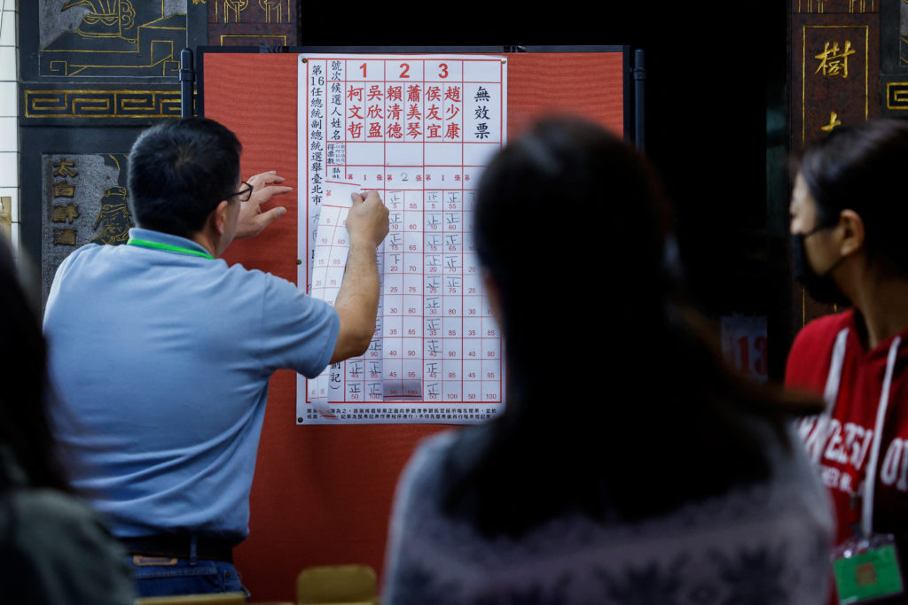 Election workers count ballots at a polling station during the presidential and parliamentary elections in Taipei