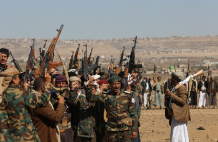 Houthi fighters and tribal supporters hold up their firearms during a protest against recent U.S.-led strikes on Houthi ta...