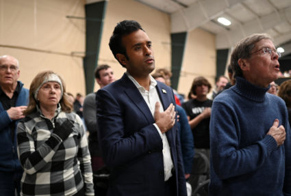 Republican presidential candidate and businessman Vivek Ramaswamy recites the Pledge of Allegiance as he visits a caucus site at Horizon Event Center in Clive, Iowa, U.S. January 15, 2024. Photo by Sergio Flores/REUTERS