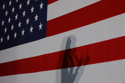 Republican presidential candidate and former U.S. Ambassador to the United Nations Nikki Haley casts a shadow on a U.S. flag while speaking at a campaign rally ahead of the New Hampshire primary election, in Rochester, New Hampshire, U.S., January 17, 2024. Photo by Brian Snyder/REUTERS