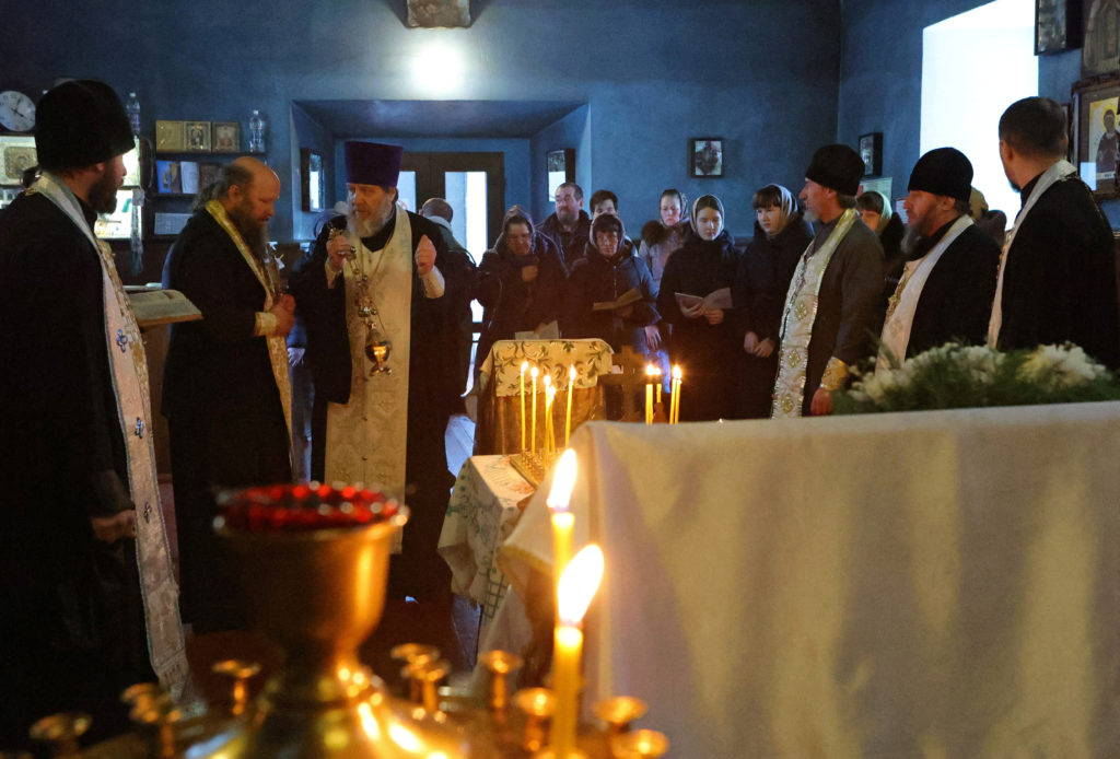 An Orthodox priest conducts a service for those killed in the crash of the Russian Ilyushin Il-76 military transport plane...