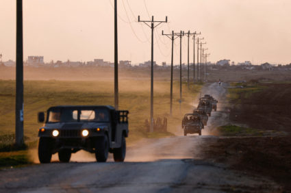 A convoy drives by at the Israel-Gaza border