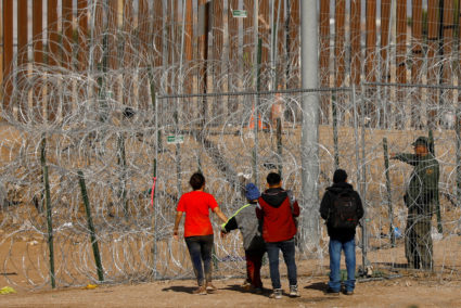 Migrants gather near razor wire on U.S.-Mexico border, as seen from Ciudad Juarez