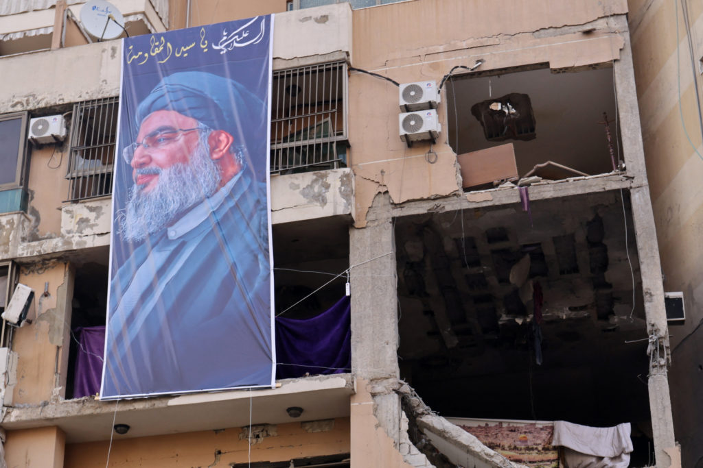 This photograph taken on January 8, 2024 shows a banner depicting Hezbollah Secretary General Hassan Nasrallah hanging on ...