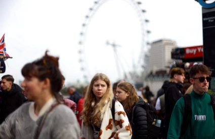 FILE PHOTO: Tourists cross Westminster Bridge in London