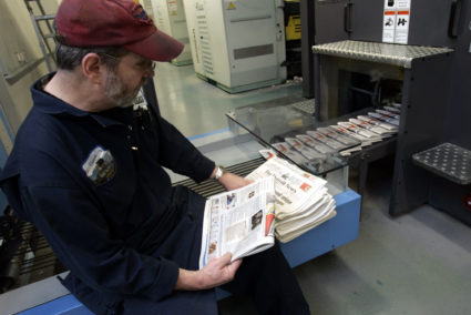 A Detroit Newspapers pressman checks newly printed Detroit News newspapers for printing errors at the newspapers printing ...