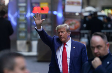 Former U.S. President Donald Trump walks outside a Trump property in New York City