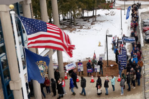 Voters line up to cast their ballots in the New Hampshire primary election in Londonderry