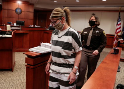 FILE PHOTO: Jennifer Crumbley, the parent of accused Oxford High School gunman Ethan Crumbley, is escorted into the courtroom by a Oakland County Sheriff during a court procedural hearing in Rochester Hills, Michigan, U.S., February 24, 2022. Photo by Rebecca Cook/Reuters
