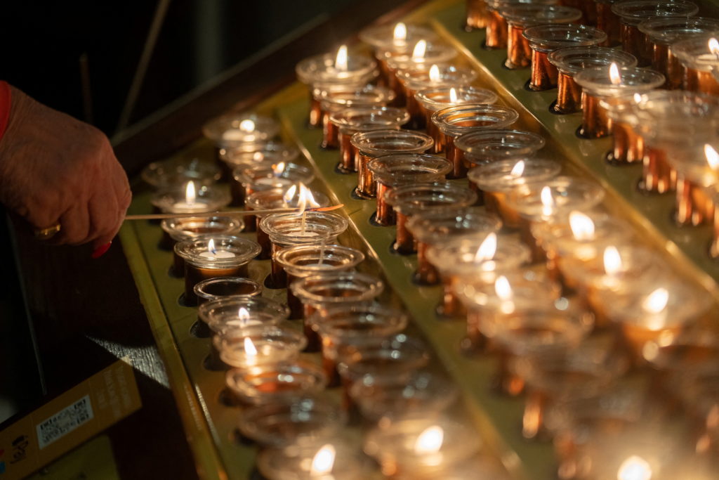 A visitor lights a candle at St. Patrick's Cathedral on Christmas Eve in New York