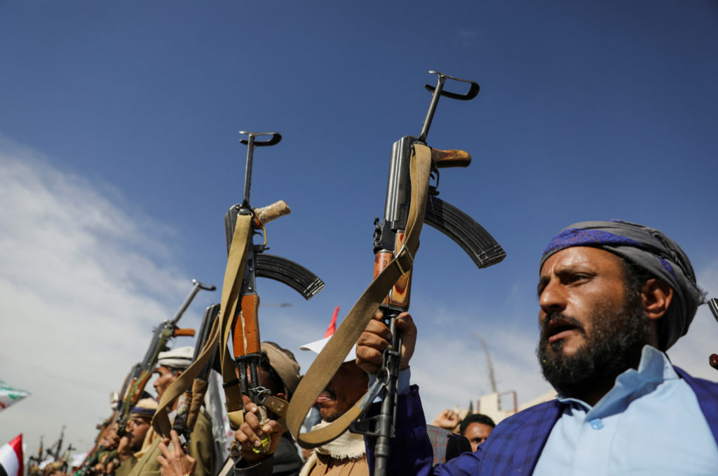Houthi followers, carrying guns, take part in a parade as part of a 'popular army' mobilization campaign by the movement, ...