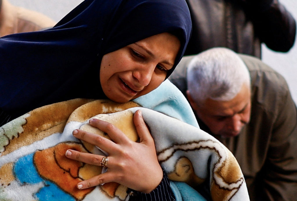 A mourner reacts next to the bodies of Palestinians, at Abu Yousef al-Najjar hospital in Rafah
