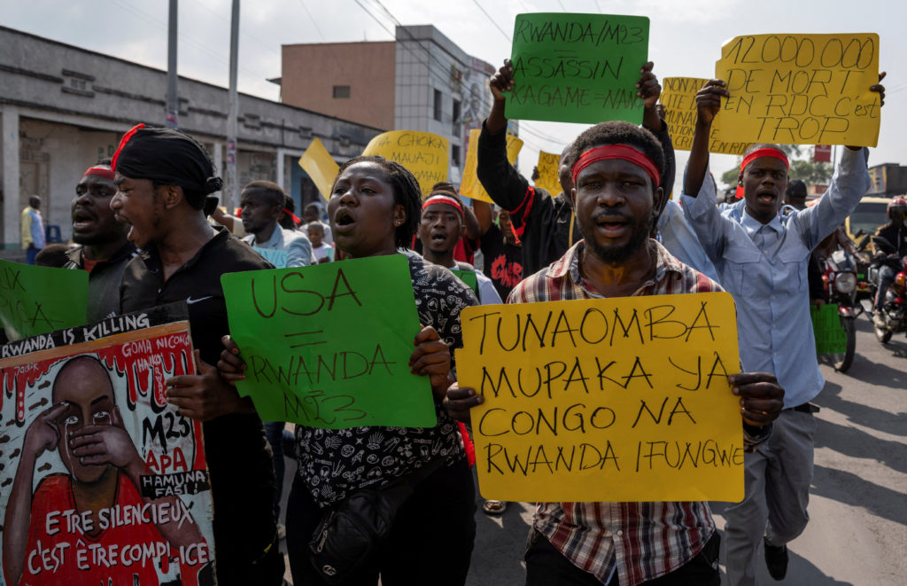 Activists march during a demonstration calling for an end to the fighting between the M23 rebels and the Congolese army an...