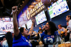 Patel, 29, celebrates after making her bets at the FANDUEL sportsbook during the Super Bowl LIII in East Rutherford, New J...