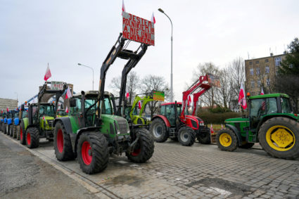 FILE PHOTO: A placard is displayed on a tractor as Polish farmers protest over price pressures, taxes and green regulation, grievances shared by farmers across Europe, in Wroclaw, Poland, February 15, 2024. The placard reads: "I am a farmer! And not the Union's slave!" Tomasz Pietrzyk/Agencja Wyborcza.pl via REUTERS