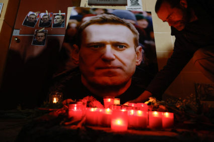 A man lights a candle at a makeshift memorial for Russian opposition leader Alexei Navalny as people attend a protest and vigil held in front of the Russian embassy following the death of Navalny, in Kappara, Malta, February 19, 2024. Photo by Darrin Zammit Lupi/Reuters