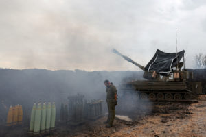 FILE PHOTO: Israeli soldiers stand by near the Israel-Lebanon border