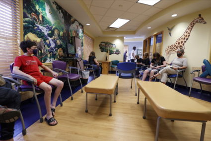 Aidan Mohl, 13, joins others in a waiting room after receiving Pfizer's vaccine against coronavirus disease (COVID-19), af...