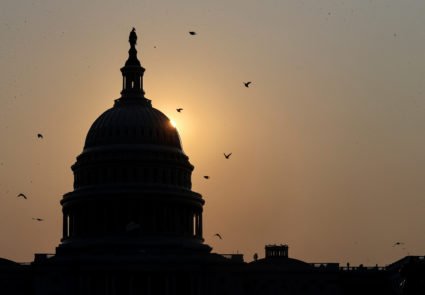 FILE PHOTO: The sun rises behind the U.S. Capitol in Washington