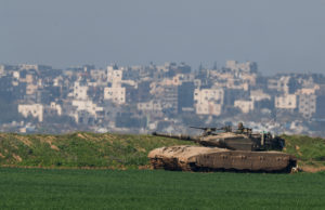 An Israeli tank manoeuvres along the northern Gaza Strip border