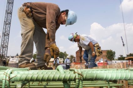 File image of construction workers attaching rebar supports during construction of new condominium at City Vista developme...