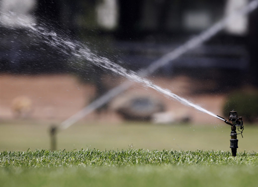 Sprinklers spray water on grass in Los Angeles June 29, 2007. Photo by Mario Anzuoni/Reuters