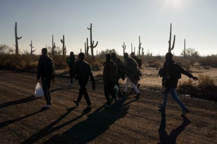 Migrants cross the border from Mexico into Arizona