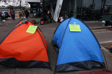 Eviction notices from the city of San Diego are attached to homeless tents on a city sidewalk, in San Diego, California, U.S., February 26, 2024. Photo by Mike Blake/Reuters