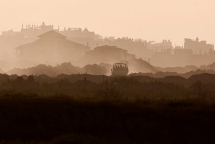 A jeep maneuvres at the Gaza Strip, as seen from Southern Israel