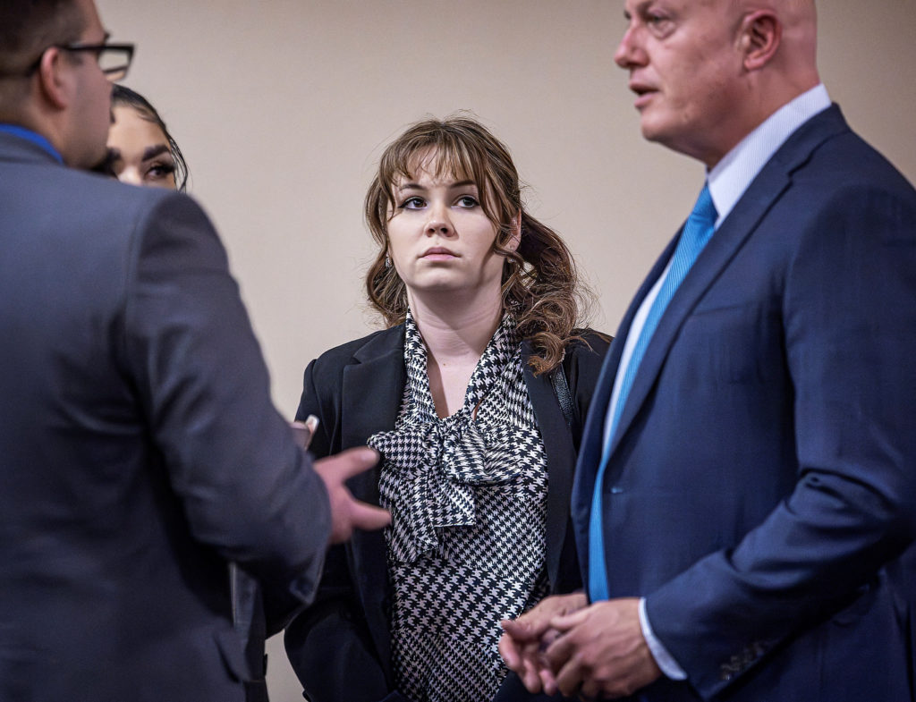 Hannah Gutierrez-Reed (center) talks with her attorney Jason Bowles (right) and her defense team during the trial against ...