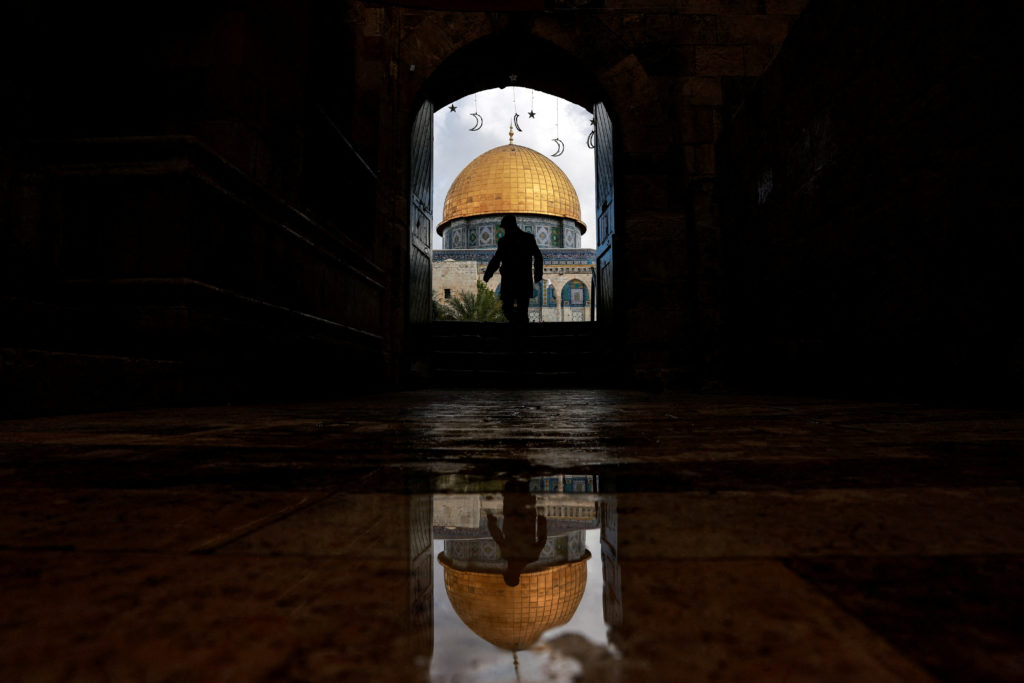 A man walks by the entrance to the al-Aqsa compound, also known to Jews as the Temple Mount, in Jerusalem's Old City