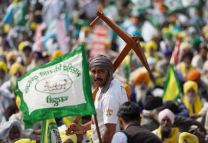 A farmer holds a mock plough as he attends a Maha Panchayat or grand village council meeting as part of a farmers' protest to press for the better crop prices promised to them in 2021, New Delhi, India, March 14, 2024. Photo by Adnan Abidi/Reuters