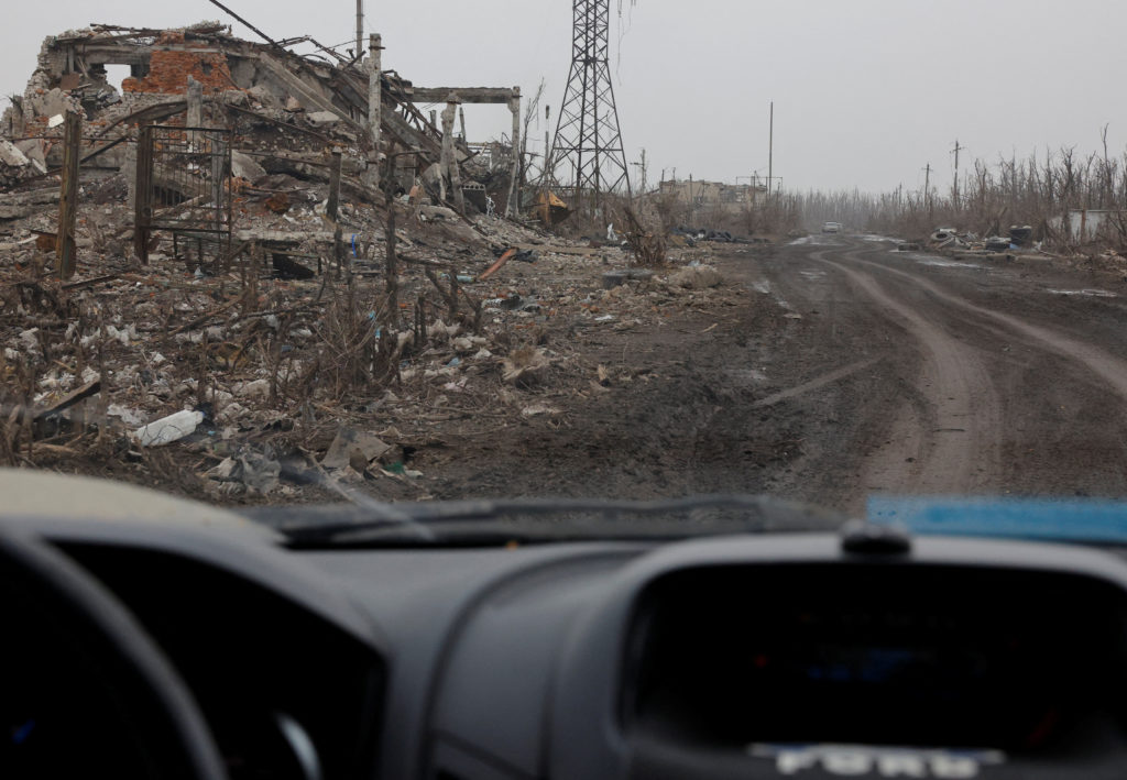 A view from a car shows destroyed buildings in Avdiivka