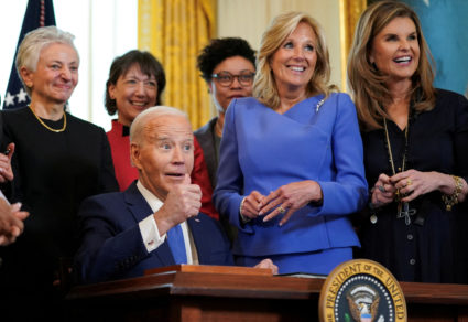 First lady Jill Biden and Maria Shriver smile as U.S. President Joe Biden gives a thumbs up after signing an executive order to expand and improve research on women's health during a Women's History Month reception at the the White House in Washington, U.S., March 18, 2024. Photo by Kevin Lamarque/Reuters