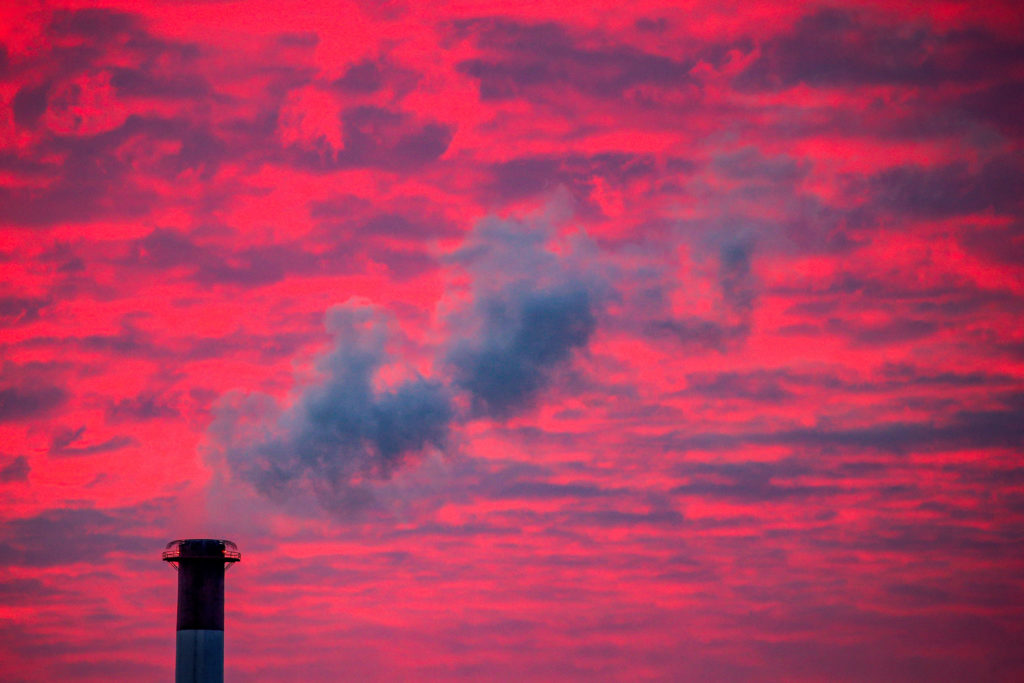 FILE PHOTO: Steam rises from a smoke stack at sunset in Lansing, Michigan, U.S., January 17, 2018. Photo by Brendan McDerm...