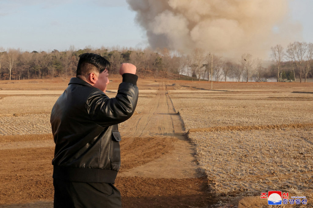 North Korean leader Kim Jong Un gestures as he guides a training of the fire division, in North Korea, March 18, 2024, in ...