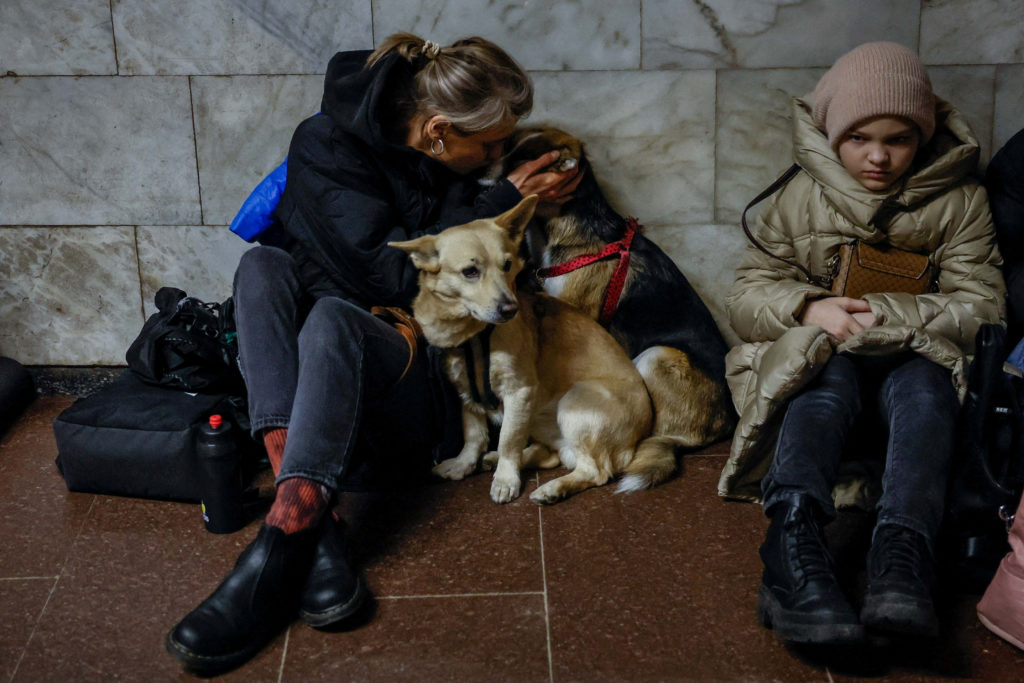 People take shelter inside a metro station during a Russian missile strike in Kyiv