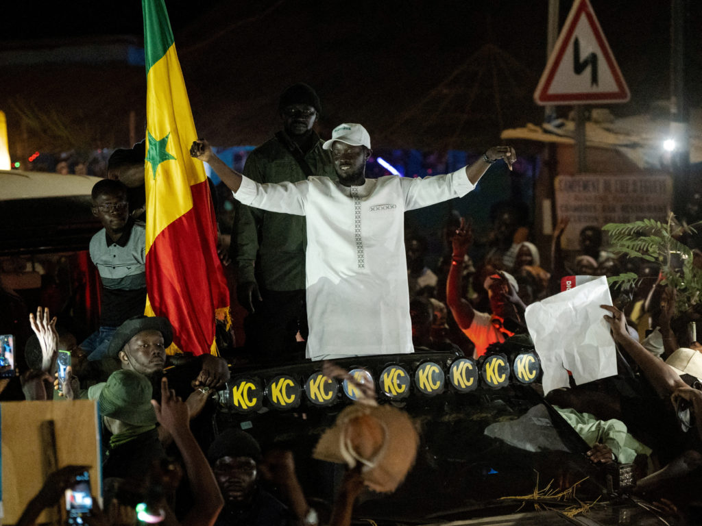 FILE PHOTO: Presidential candidate Bassirou Diomaye Faye cheers on supporters during his electoral campaign caravan in Zin...