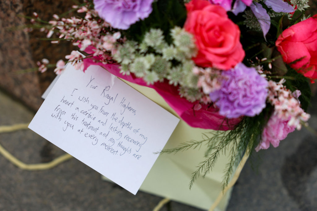 A message for Britain's Catherine, Princess of Wales, is placed on a bouquet of flowers near Windsor Castle, the day after...