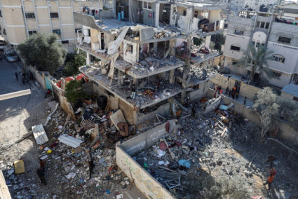 Palestinians inspect the site of an Israeli strike on a house, in Rafah, in the southern Gaza Strip