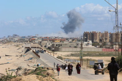 Smoke rises following an Israeli strike as Palestinians fleeing north Gaza due to Israel’s military offensive move southwa...