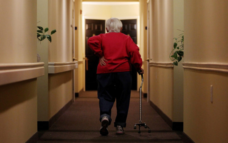 Inez Willis walks down the hallway to visit a neighbor at her independent living complex in Maryland