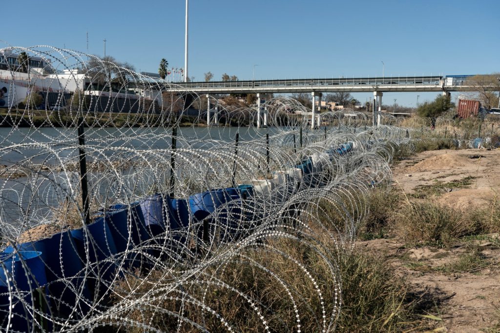 FILE PHOTO: Migrants cross the border into Texas from Mexico