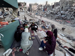 Gaza family breaks Ramadan fast on the rubble of their destroyed house, in Beit Lahia in the northern Gaza Strip