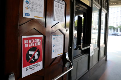 A sign forbidding guns is seen outside a polling station for the U.S. presidential election at the Wiltern Theatre during ...